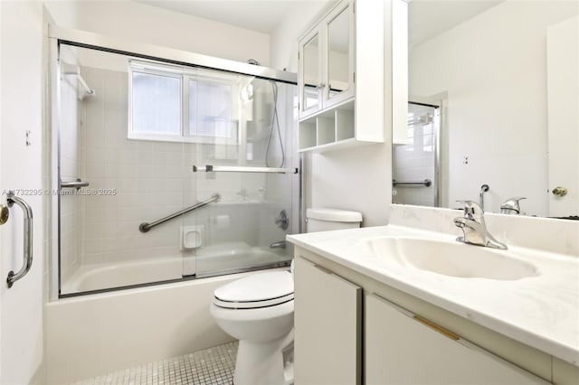 full bathroom featuring toilet, vanity, shower / bath combination with glass door, and tile patterned flooring