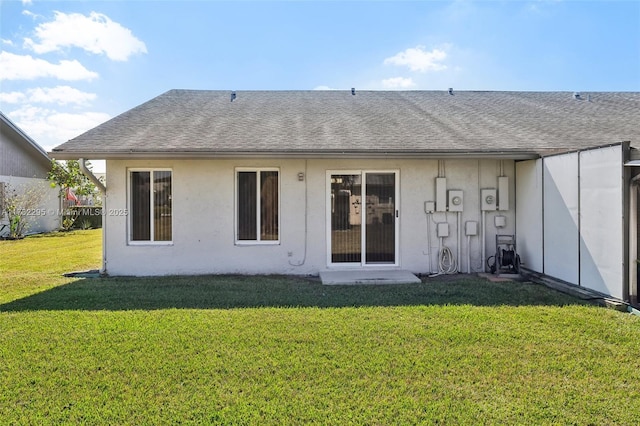 rear view of house featuring a yard