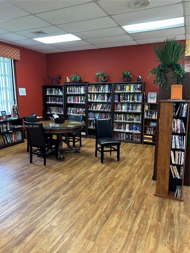 office space featuring hardwood / wood-style flooring and a drop ceiling