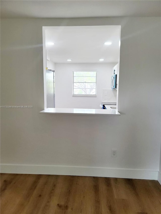 empty room with dark hardwood / wood-style floors