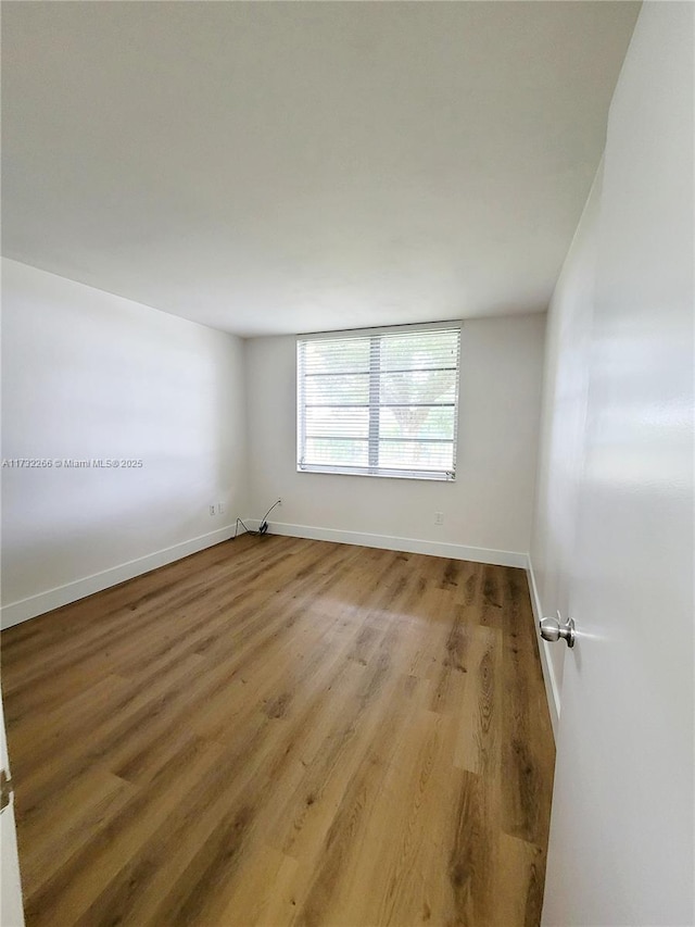 spare room with hardwood / wood-style floors