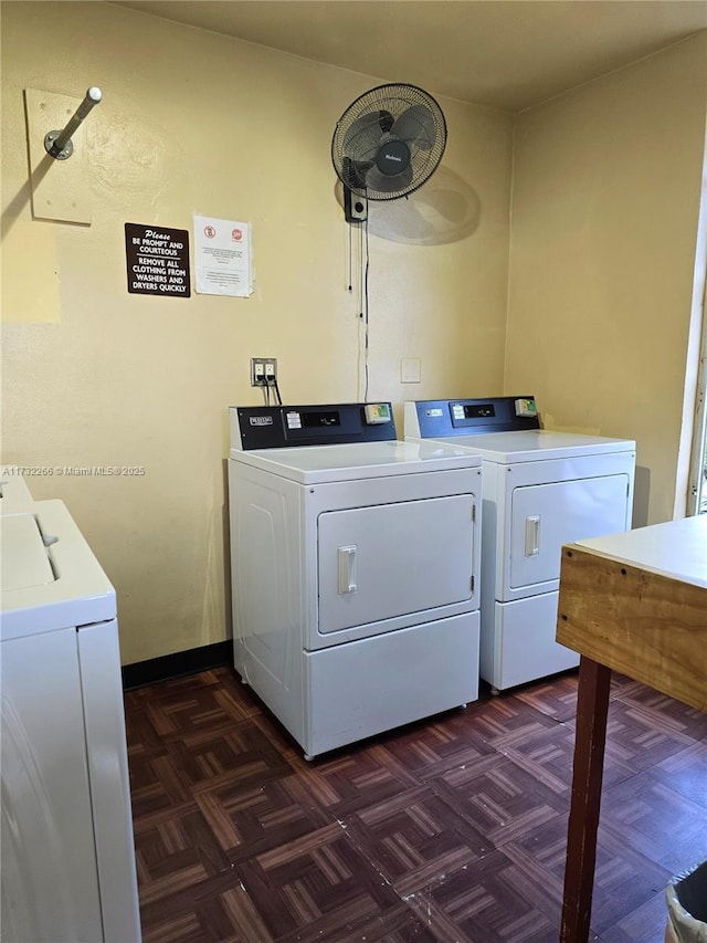 laundry area with washer and dryer and dark parquet floors