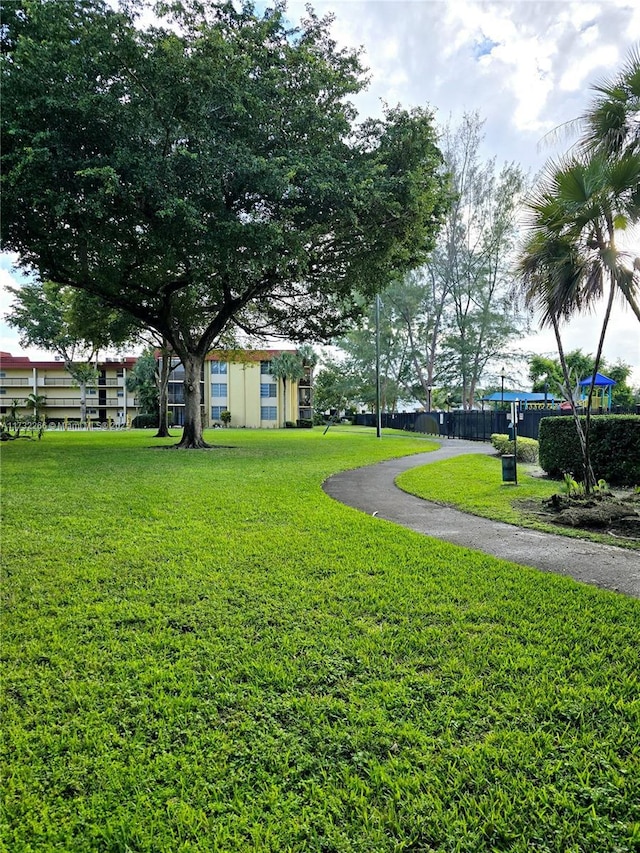 view of home's community with a yard