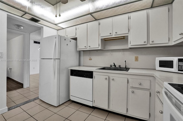 kitchen featuring white cabinetry, sink, white appliances, and light tile patterned floors