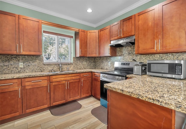 kitchen featuring appliances with stainless steel finishes, sink, ornamental molding, light stone countertops, and light wood-type flooring