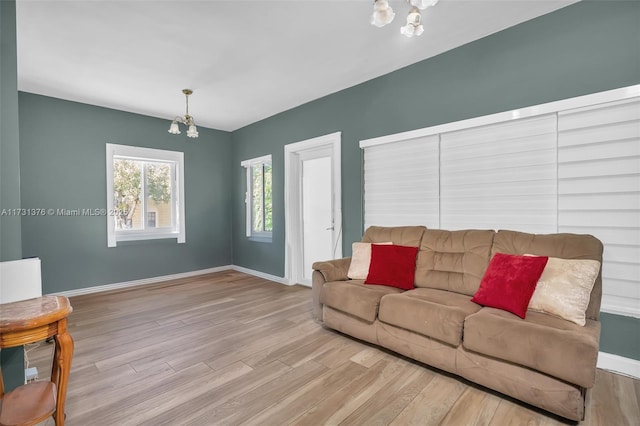 1959 SW 12th St, Miami, FL 33135 - living room with a chandelier, wood finished floors, and baseboards