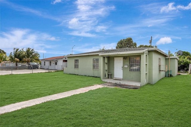 rear view of property with a lawn