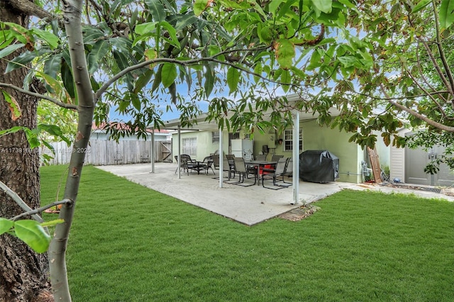 back of house with a patio and a lawn