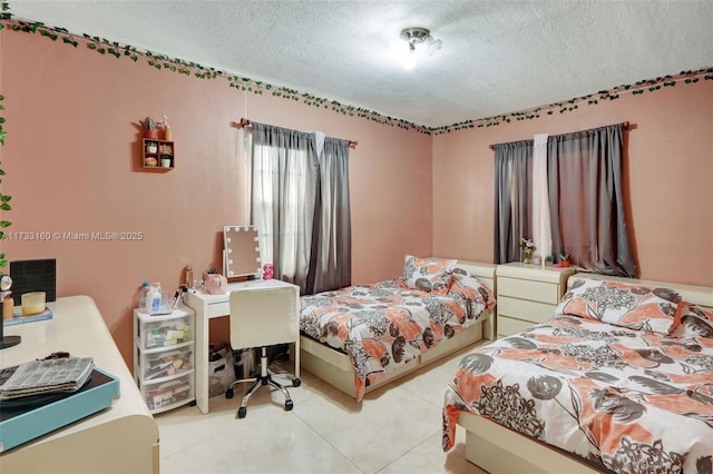 tiled bedroom featuring a textured ceiling