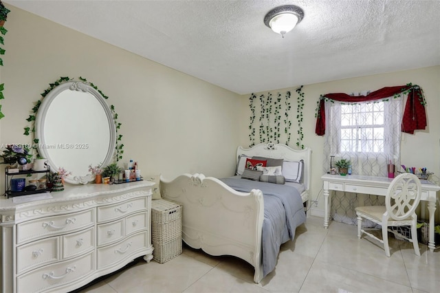 bedroom with light tile patterned floors and a textured ceiling