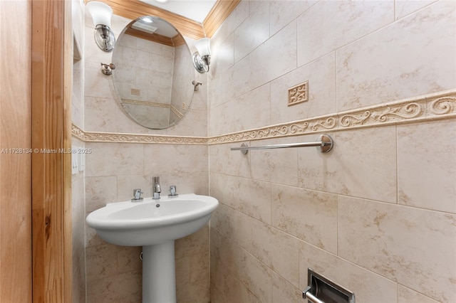 bathroom with crown molding and tile walls