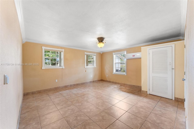 unfurnished room featuring crown molding and light tile patterned flooring