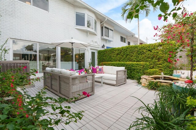 view of patio with an outdoor living space and a wooden deck
