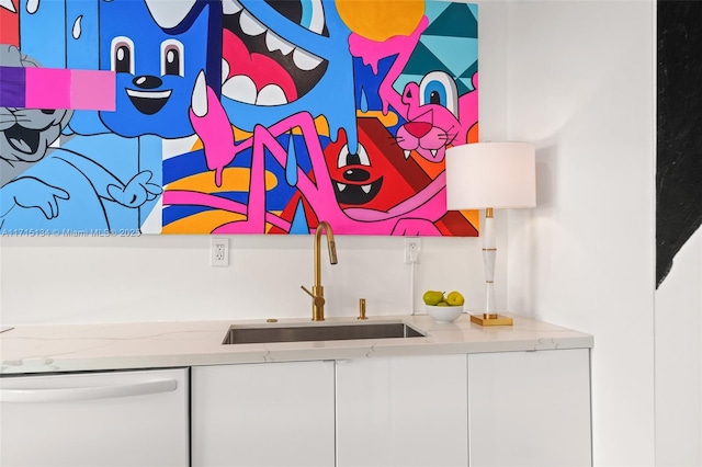 bar with dishwasher, sink, and white cabinets