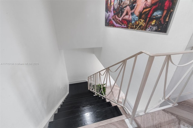 stairs featuring wood-type flooring