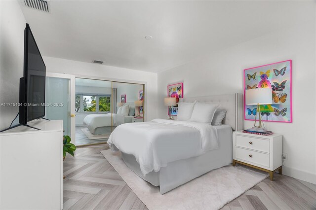 bedroom featuring a closet and light parquet flooring