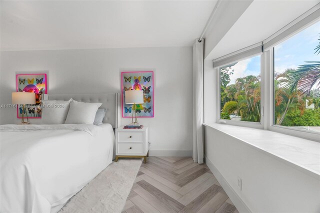 bedroom with light parquet flooring