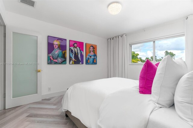 bedroom featuring light parquet floors