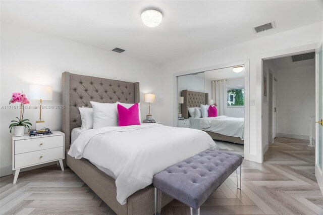 bedroom featuring a closet and light parquet flooring