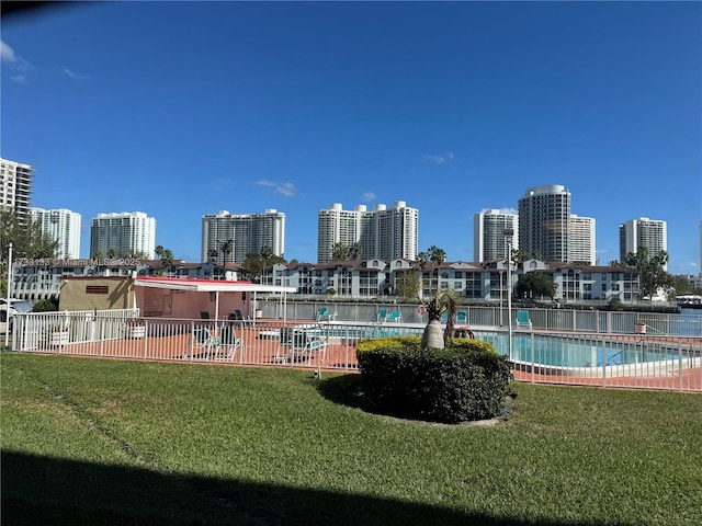 view of pool featuring a lawn