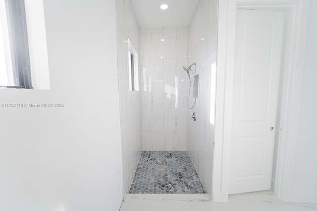 bathroom with tiled shower