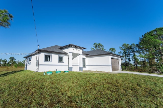 view of front of home with a garage and a front yard