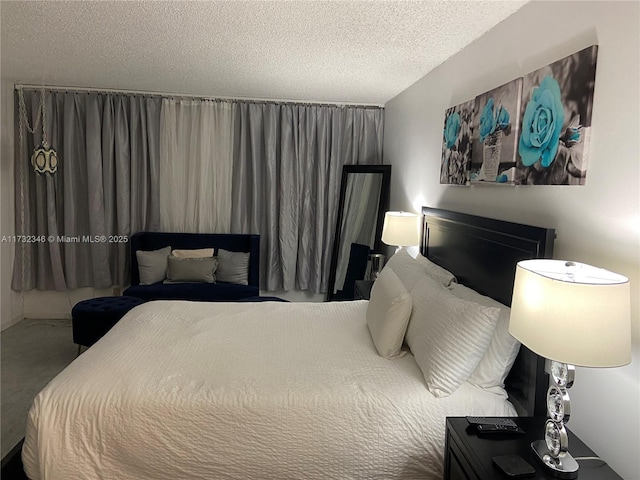 bedroom featuring carpet floors and a textured ceiling