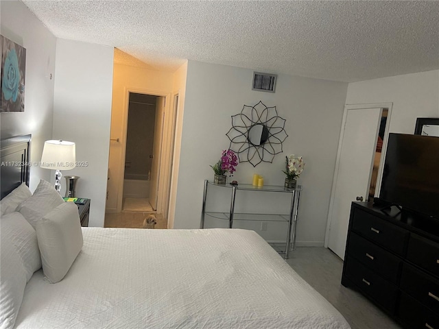 bedroom with connected bathroom and a textured ceiling