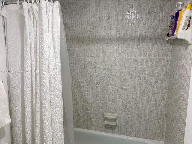 bathroom with shower / bathtub combination with curtain