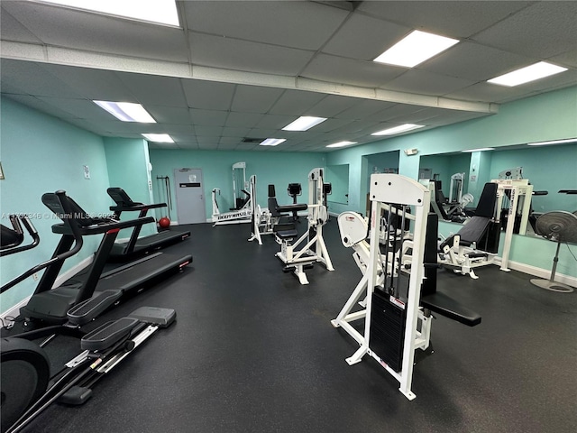 workout area with a paneled ceiling