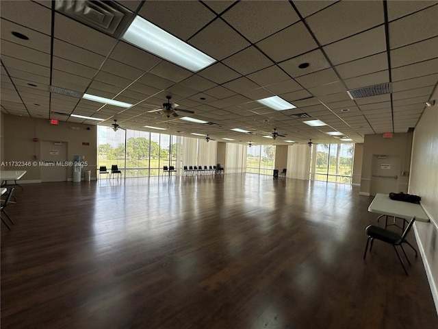 interior space featuring a paneled ceiling, plenty of natural light, and hardwood / wood-style floors