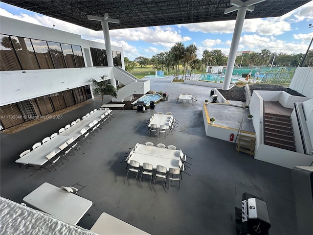 view of patio with a bar and a community pool