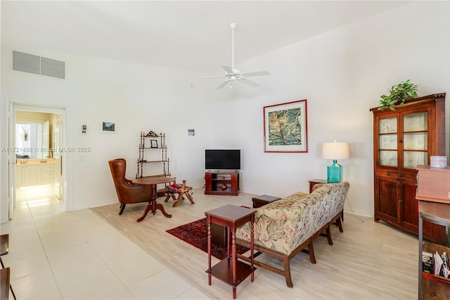 living room with ceiling fan and light hardwood / wood-style floors