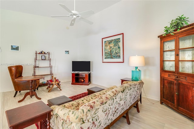 living room with ceiling fan and light wood-type flooring