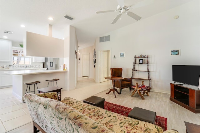 tiled living room with ceiling fan