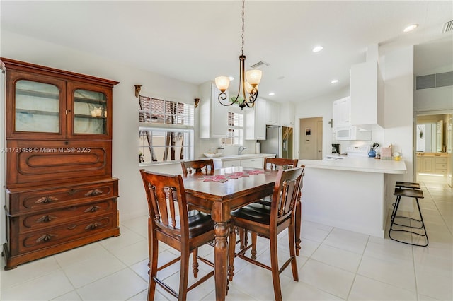 dining room with light tile patterned floors, sink, and a chandelier