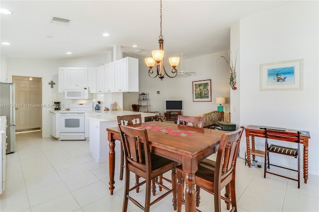 tiled dining room featuring a notable chandelier