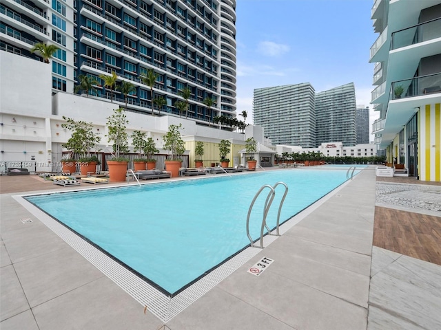 view of swimming pool featuring a patio area