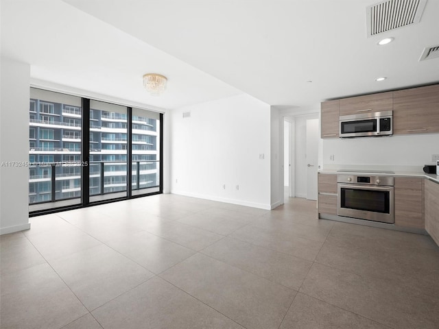 kitchen featuring stainless steel appliances and expansive windows