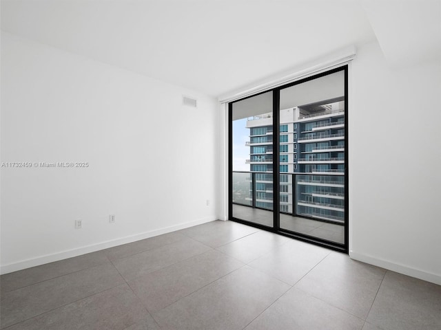 spare room featuring expansive windows