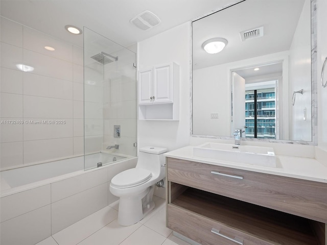 full bathroom featuring tiled shower / bath combo, vanity, tile patterned floors, and toilet