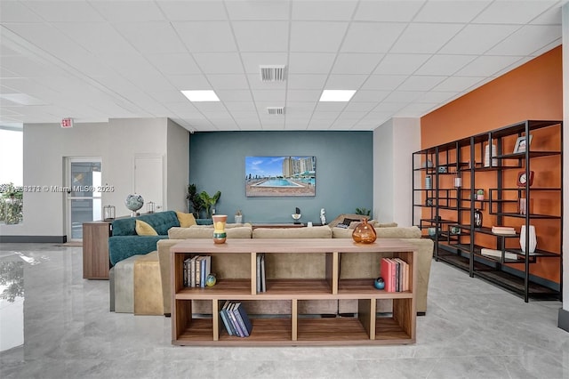 living room with a paneled ceiling