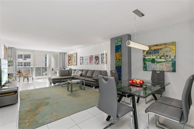 dining space with a wall of windows and light tile patterned floors