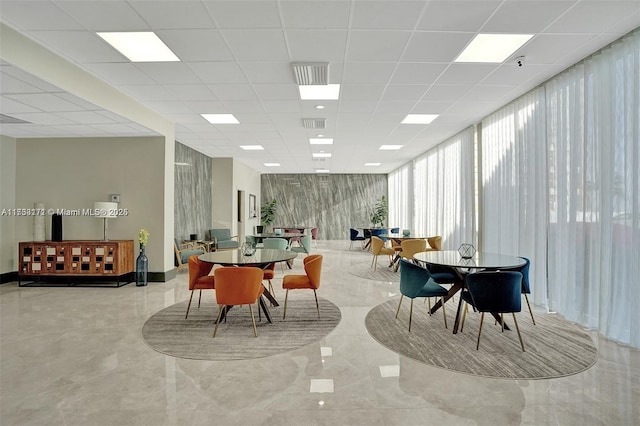 dining room with a drop ceiling