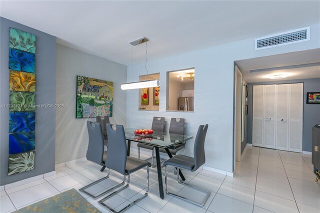 dining area with light tile patterned floors