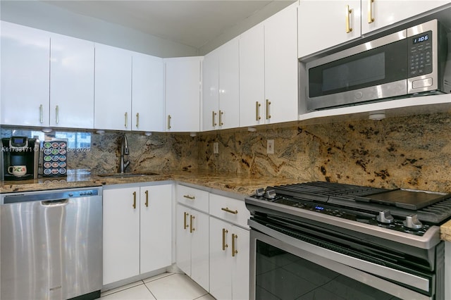 kitchen featuring white cabinetry, backsplash, stainless steel appliances, and sink