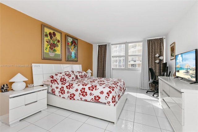 bedroom with light tile patterned floors