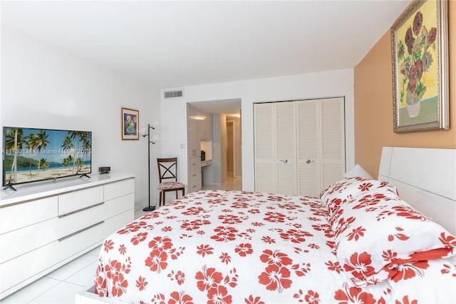 tiled bedroom with a closet