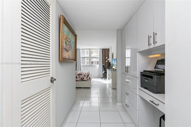 kitchen with white cabinetry and light tile patterned floors