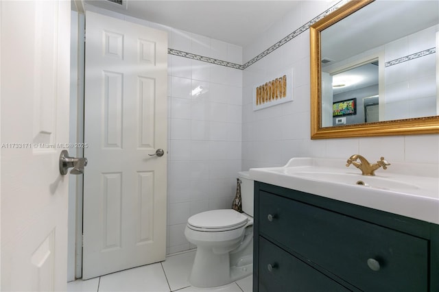 bathroom featuring tile walls, vanity, tile patterned floors, and toilet